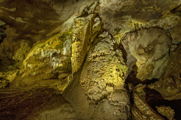 Beautiful cave with stalactites underground cavern in magic light