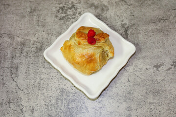 Baked brie topped with raspberry jam and wrapped in puff pastry.