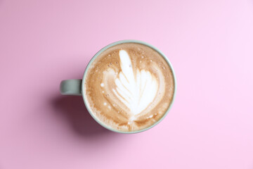 hot cappuccino with latte art isolated in pink background