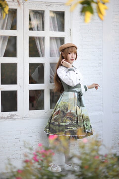 A beautiful woman in lolita dress in garden background Japanese street fashion portrait