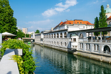 Fototapeta na wymiar Ljubljanica River adjacent to Plečnik's Market in the town center of Ljubljana