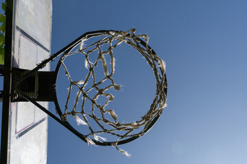 Vintage street basketball hoop. In the middle of nature, with trees around. Sunny day