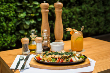 Sliced chicken fillet over steamed vegetables and chimichurri sauce food gourmet