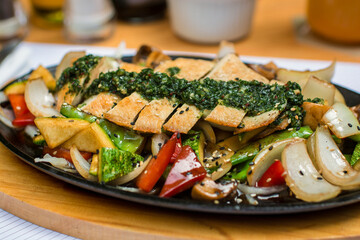 Sliced chicken fillet over steamed vegetables and chimichurri sauce food gourmet