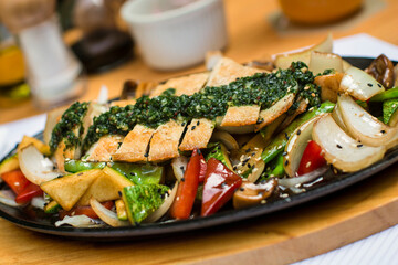Sliced chicken fillet over steamed vegetables and chimichurri sauce food gourmet