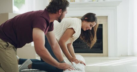 Teamwork, family and happy couple rolling out a carpet on the floor in new home, house or living room together. Man and woman moving in working, collaboration and design interior for their new house.