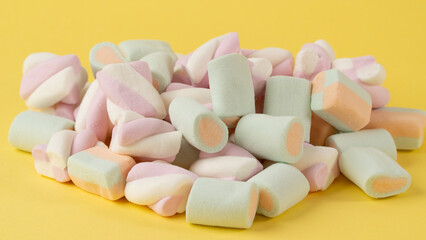 Close-up of marshmallows on a yellow background