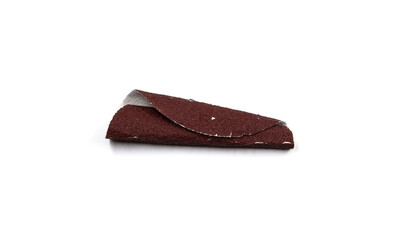Red sandpaper that has been used and twisted.