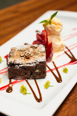 Fototapeta na wymiar Chocolate brownie dessert with strawberries and ice cream