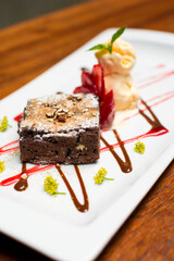 Chocolate brownie dessert with strawberries and ice cream