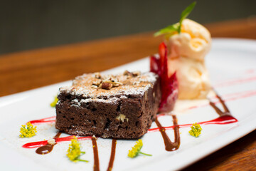 Chocolate brownie dessert with strawberries and ice cream