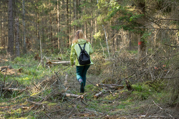 Woman play Geocaching. Walk in deep forest.