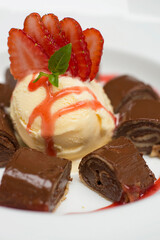 Chocolate pancakes crepe with ice cream and strawberries
