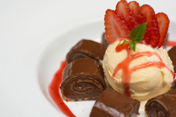 Chocolate pancakes crepe with ice cream and strawberries