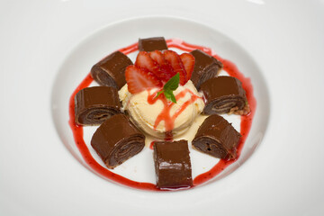 Chocolate pancakes crepe with ice cream and strawberries