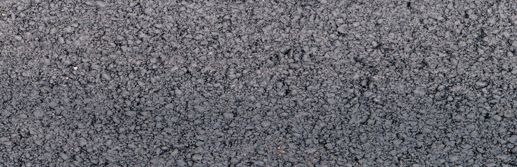 Panorama of asphalt road surface with gravel pattern. grainy background texture