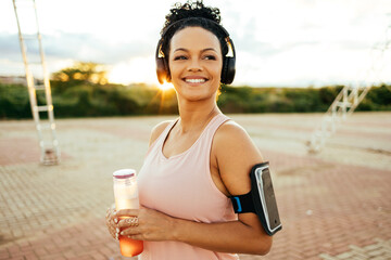 Portrait of athlete woman relaxing after work out outdoors.