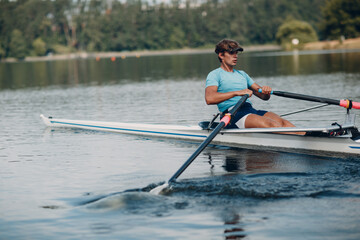 Sportsman single scull man rower rowing on boat. © primipil