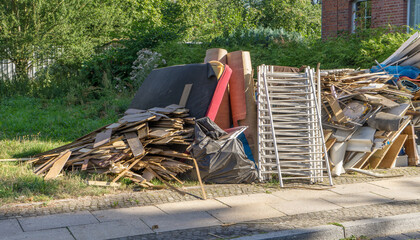 Bulky garbage heap at the roadside with furniture