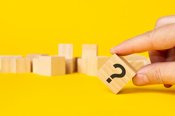 wooden block with icon question symbol on yellow background - obrazy, fototapety, plakaty