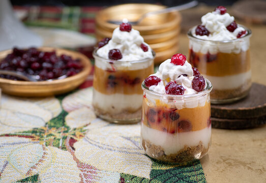 Christmas pumpkin and cramberry mousse served in individual glasses