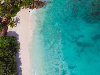 Aerial view from drone of Petise Anse beach at Mahé Island taken in the afternoon light
