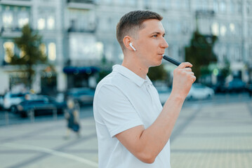 A heat-not-burn tobacco product technology.Man holding in one hand smoking module before smoking.