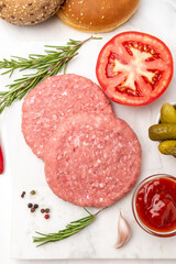 Patty of minced meat for burger. Grey background. Top view