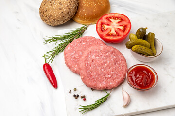 Patty of minced meat for burger. Grey background. Top view