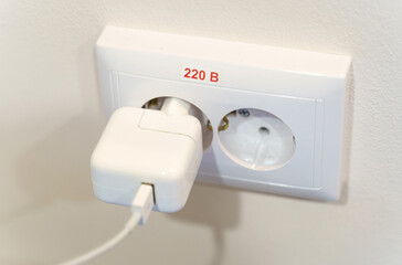 The charger of an electronic device connected to the electrical network.