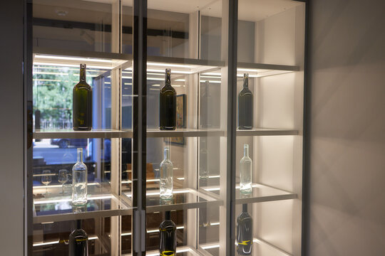 wine bottles in wooden rack in wine cellar.