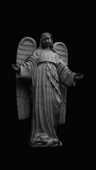 Ancient statue of angel. Black and white vertical image.