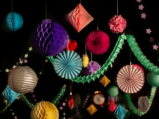 Colorful christmas or party paper lantern, stars, balls decorations on the black background