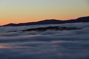 Fototapeta na wymiar peaks above the clouds