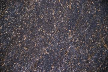 Stone black textured background. Natural stone. The black background is a blank for the design. Uneven surface.