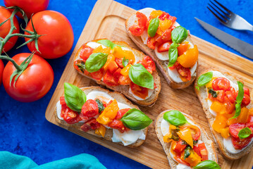 crispy bruschetta bread with mozzarella cheese with tomatoes and basil