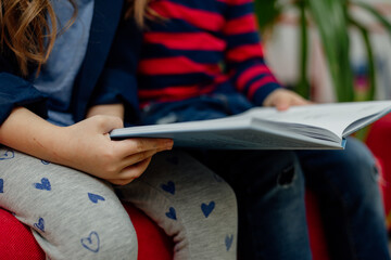 school children in the library reading books, doing homework, prepare a school project for lessons