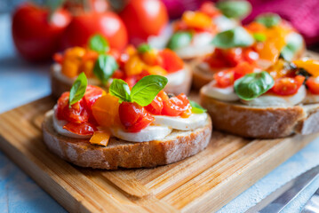 crispy bruschetta bread with mozzarella cheese with tomatoes and basil