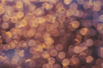 abstract christmas bokeh orange gold background, drops on the glass after rain on sunset looks like a lot of small lights