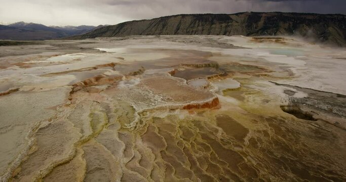 Steam rises and water bubbles in Mammoth Hot Spring in Yellowstone National Park