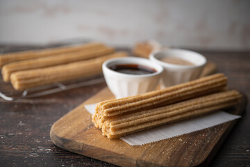 churros with chocolate sauce and cinnamon powder