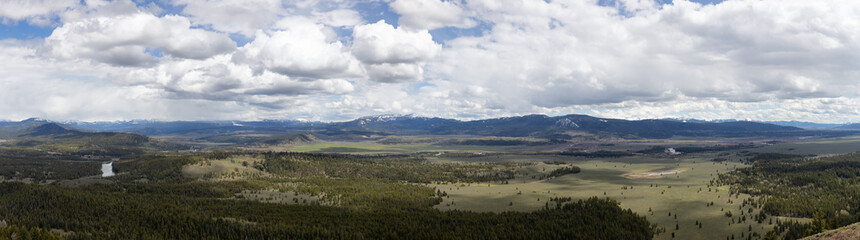 Fototapeta na wymiar Trees, Land and Mountains in American Landscape. Spring Season. Grand Teton National Park. Wyoming, United States. Nature Background Panorama