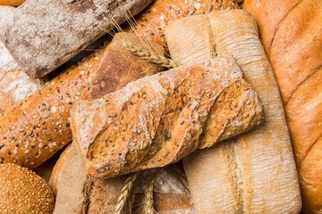 Homemade natural breads. Different kinds of fresh bread as background, top view with copy space
