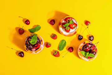 Delicious Italian dessert panna cotta with sweet cherry sauce, strawberry jam, fresh berries, mint