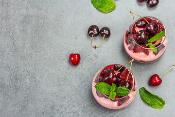 Delicious Italian dessert panna cotta with sweet cherry sauce, fresh berries and mint leaves
