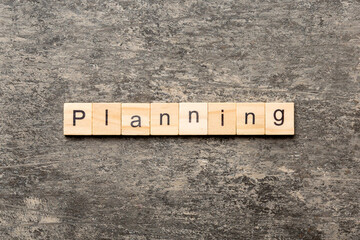 Fototapeta premium planning word written on wood block. planning text on table, concept