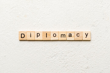 diplomacy word written on wood block. diplomacy text on cement table for your desing, concept