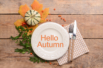 Autumn table setting with pumpkin on wooden background