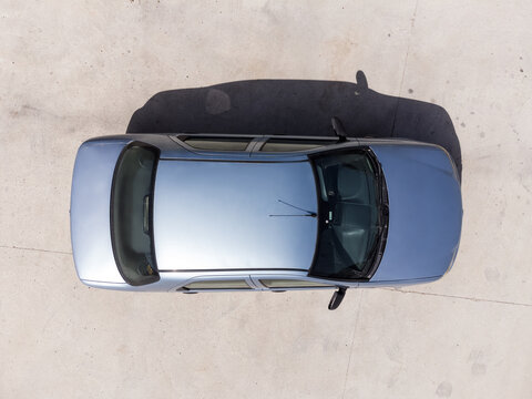 Aerial top view of a blue colored Fiat brand albea model 2006 car on the road.