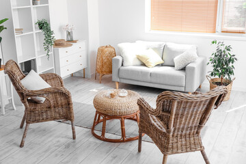 Interior of cozy living room with rattan armchairs and table